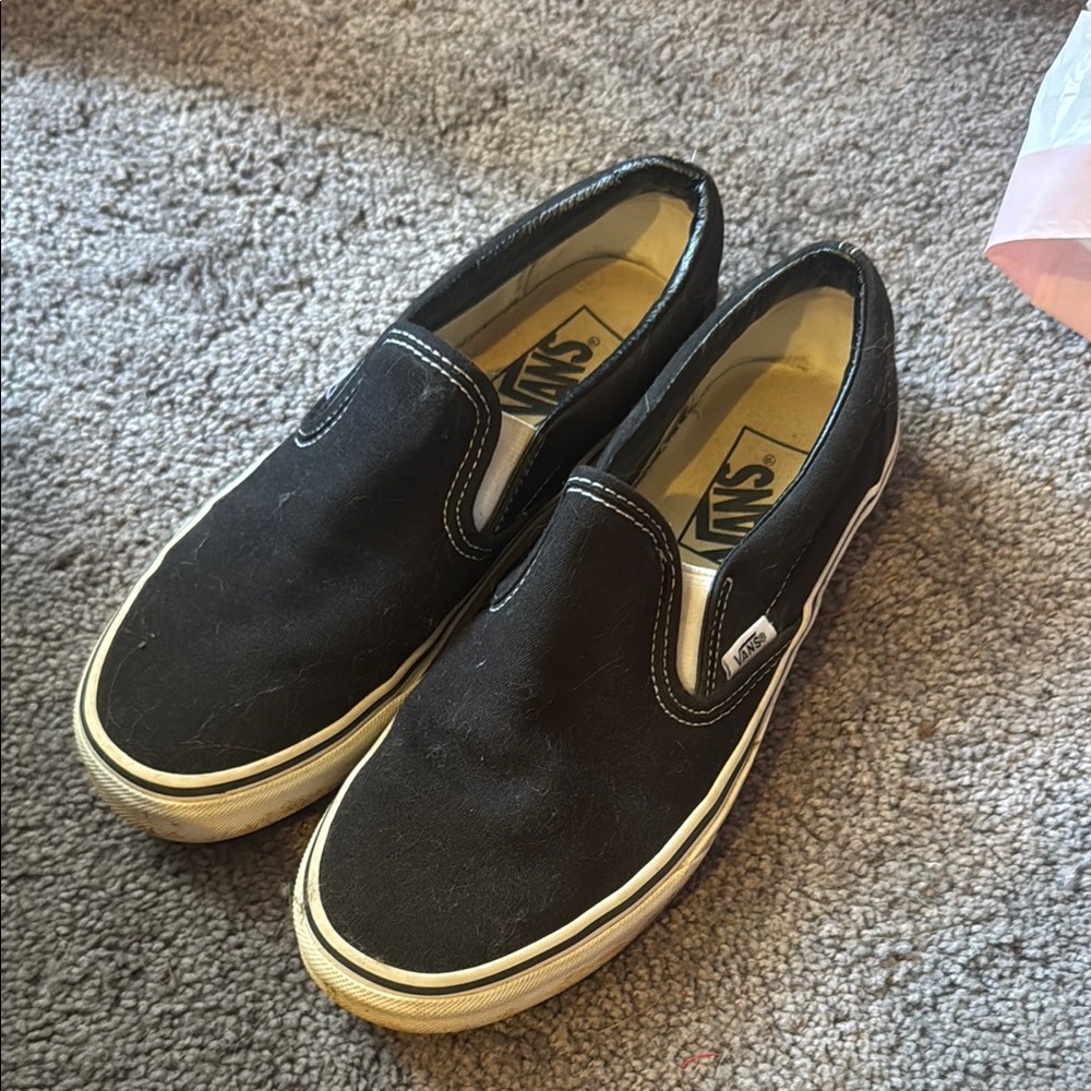 Vans women’s Black and White Slip-On Sneakers